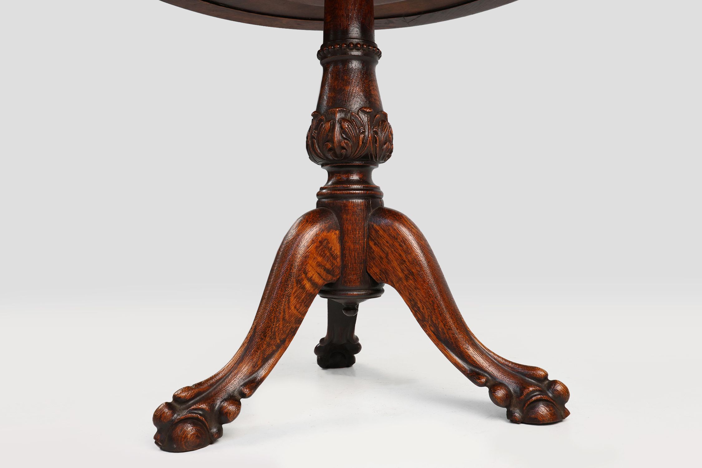 Antique English hand carved circular oak side table with lions head feet thumbnail